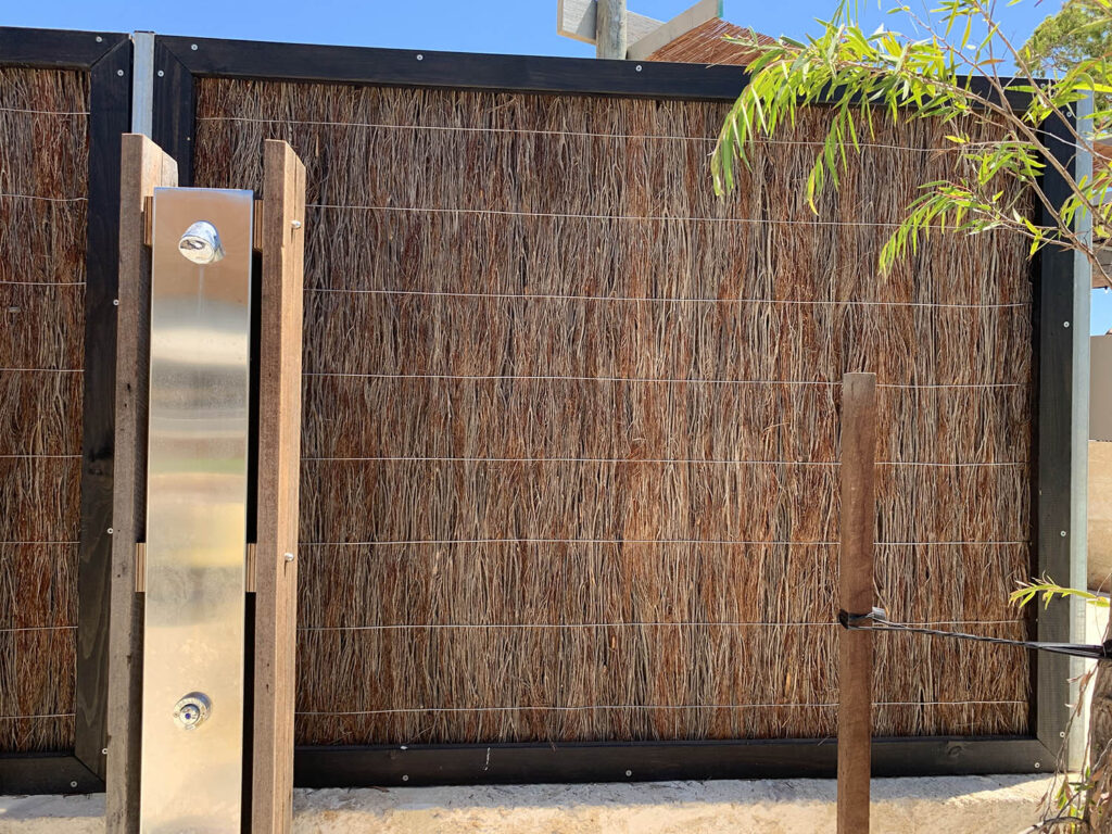 Bowman Brush brushwood fence behind a fancy shower-head at Rottnest Samphire Resort.